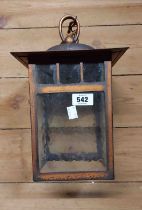 An Arts & Crafts style hanging lantern with copper frame and textured glass panels