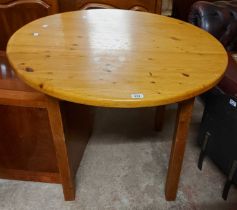 A 93cm diameter modern pine circular table, set on square legs