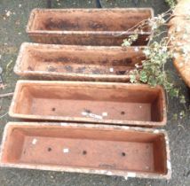 A set of four narrow oblong terracotta planters