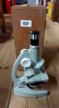 A vintage Regent Zoom 40X-900X student microscope in original wooden case