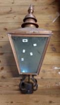 A vintage glazed garden light of streetlamp form with copper frame a wrought iron fitting