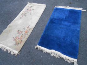 Two Chinese washed wool rugs, one with cut floral design on dark blue ground - 1.6m X 90cm, the