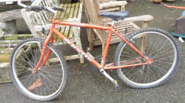 An Apollo Terra bicycle with orange finish