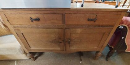 A 1.22m vintage light oak sideboard with two frieze drawers and double panelled cupboard under,