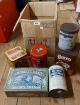 A box containing six vintage tins comprising two Bisto, three milk and one Thomas Adams
