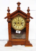 An antique small walnut cased American shelf clock with printed dial and simple German gong striking