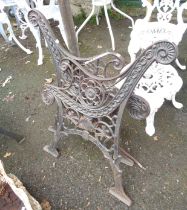 A pair of Victorian black painted ornate cast iron bench ends