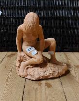 A terracotta sculpture, depicting a naked lady signed Eric Penny