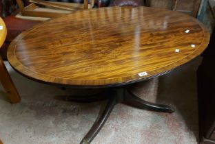 A 1.2m 19th Century mahogany and cross banded oval tilt-top loo table, set on turned pillar and