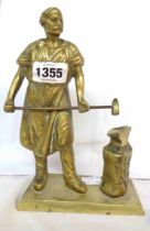 A cast brass figure, depicting a blacksmith and anvil