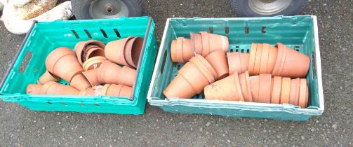 Two crates containing a quantity of small terracotta plant pots