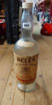 A large vintage Bell's Scotch Whisky bottle