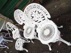 A pair of white painted cast aluminium antique style garden chairs with ornate pierced fern