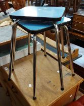 A pair of vintage tubular metal framed stools with blue Formica seats