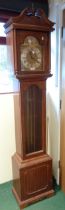 A 20th Century oak grandmother clock with silvered and brass arched dial, glazed door and triple