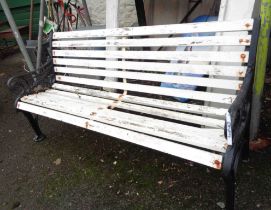 A 1.6m two seater garden bench with slatted wooden back and seat, set on black painted cast iron