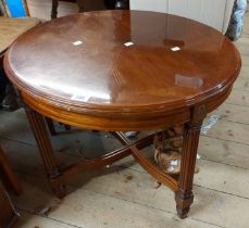 A 66cm reproduction mahogany tea table with quarter veneered oval top, set on turned and reeded legs