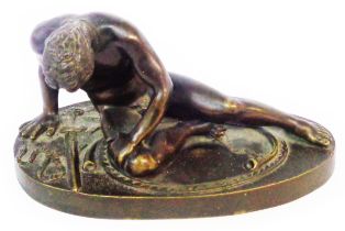 A bronze figure, depicting a wounded recumbent warrior