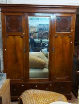A 1.55m Edwardian mahogany triple wardrobe with moulded cornice, hanging space enclosed by a