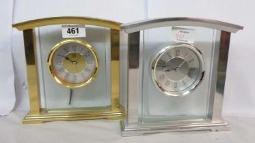 Two similar modern Marks & Spencer metal and glass framed battery timepieces, one brass, the other