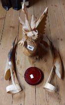 An oriental carved wooden dragon with revolving stand - sold with a pair of cow horn bird figurines