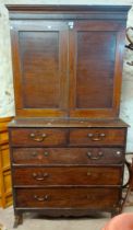 A 1.1m 19th Century mahogany two part cabinet-on-chest with adjustable shelves enclosed by a pair of