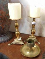 A pair of cast brass pricket candlesticks with triangular form bases - sold with an old brass