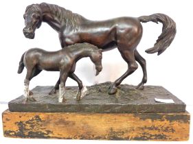A Victorian spelter mare and foal group with applied patina, set on a naturalistic base and wooden