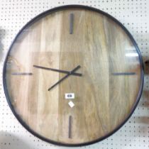 A 61cm diameter modern black metal and wood panelled wall timepiece with battery movement