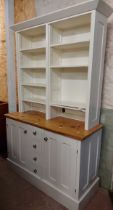 A 1.31m modern part painted pine two part dresser with adjustable shelves over a base with four