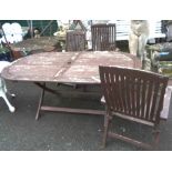 A 1.8m painted wood folding garden table - sold with three elbow chairs to match