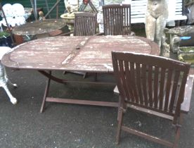 A 1.8m painted wood folding garden table - sold with three elbow chairs to match