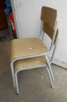 Nine vintage tubular metal framed school chairs with plywood backs and seats