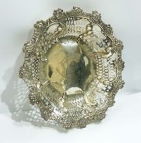 A 19.5cm diameter late Victorian silver bon bon dish with cast floral rim and pierced sides, the