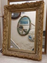 A vintage ornate plaster framed oblong wall mirror - sold with a gilt framed similar