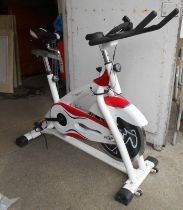A red and white metal 'Sports' exercise bike