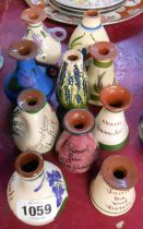 Ten Torquay pottery scent bottles of various makers and form