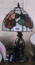 A small contemporary Tiffany style lamp with coloured glass shade