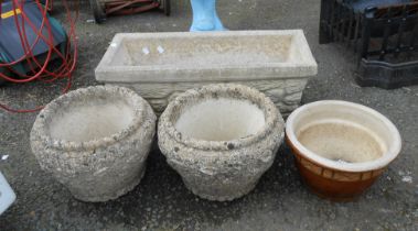 A concrete oblong planter with tapered sides - sold with a pair of circular concrete planters and