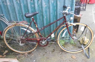 A vintage Raleigh bicycle in maroon colourway