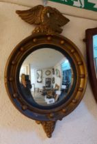 A vintage Atsonea Regency style gilt framed convex wall mirror with eagle pediment and beaded