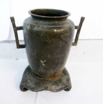 An antique Chinese bronze temple urn with integral stand and handles - a/f