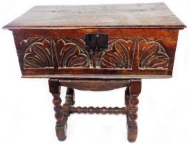 A 59cm 18th Century oak bible box and stand with carved decoration to front, set on an associated