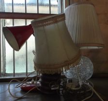 Three table lamps comprising a cut glass example, a turned wood lamp and a red metal desk lamp