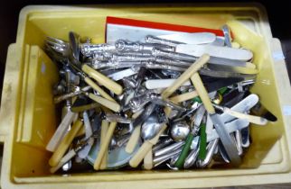 A crate containing a large quantity of silver plated and other cutlery