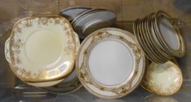 A crate containing a quantity of porcelain and bone china tableware with gilt decoration