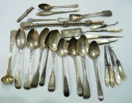 A bag containing antique English silver assorted teaspoons, parcel gilt silver preserve ladle,