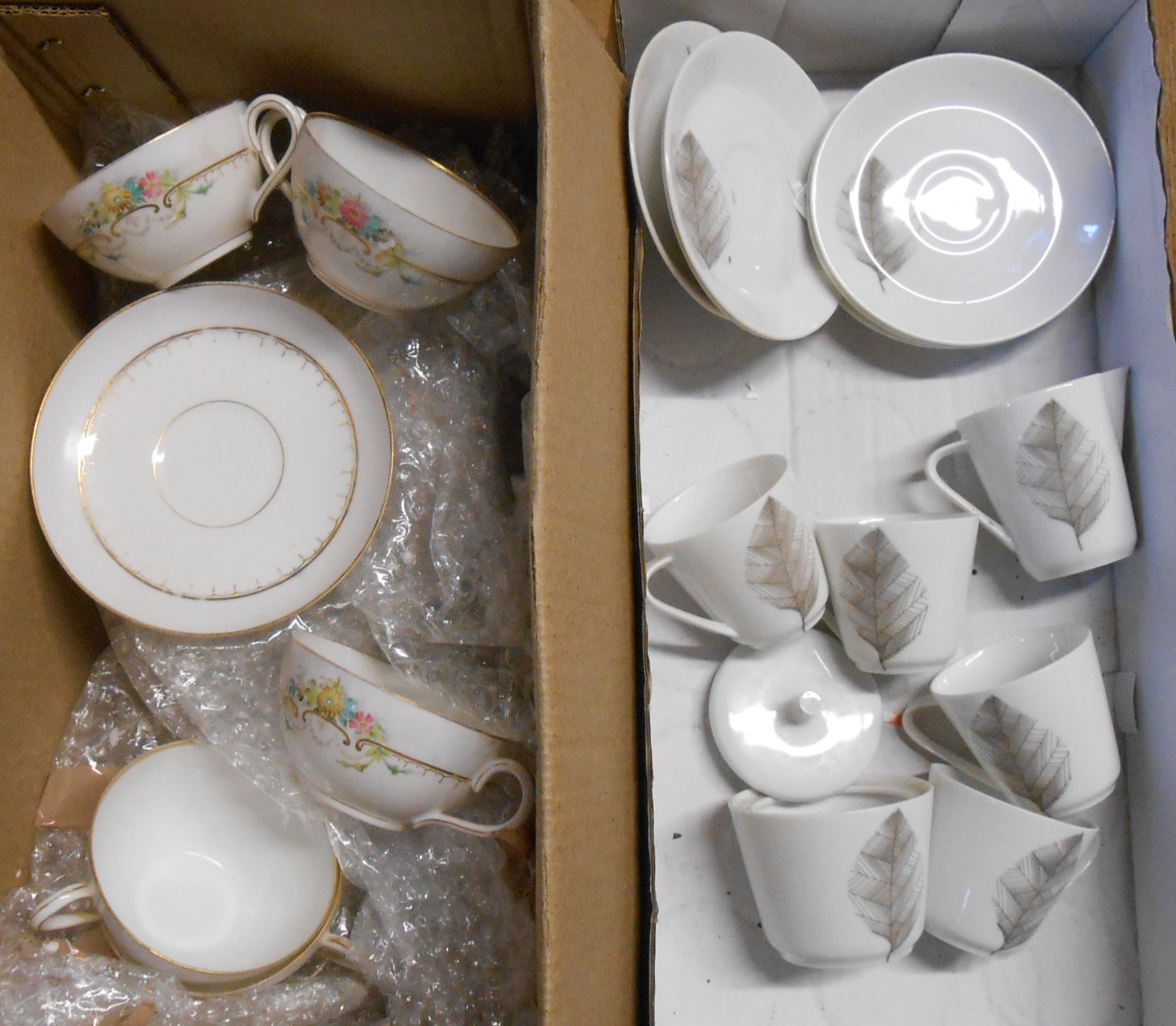 A box containing a vintage Hutschenreuther porcelain part coffee set and another similar