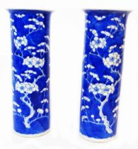 A pair of antique Chinese porcelain vases of cylindrical form, with flared rims, decorated all