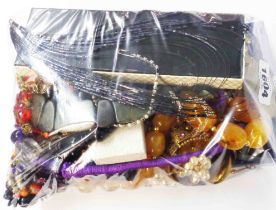 A bag containing a quantity of assorted costume jewellery including necklaces and other boxed items